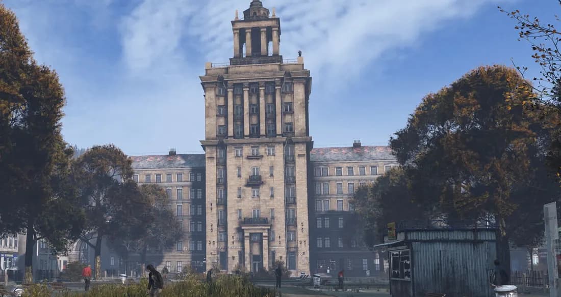 A square in Chernarus in DayZ, with a tower, apartment blocks and autumn trees